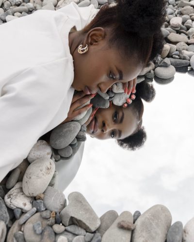 young-woman-dressed-white-posing-with-mirror-rocks